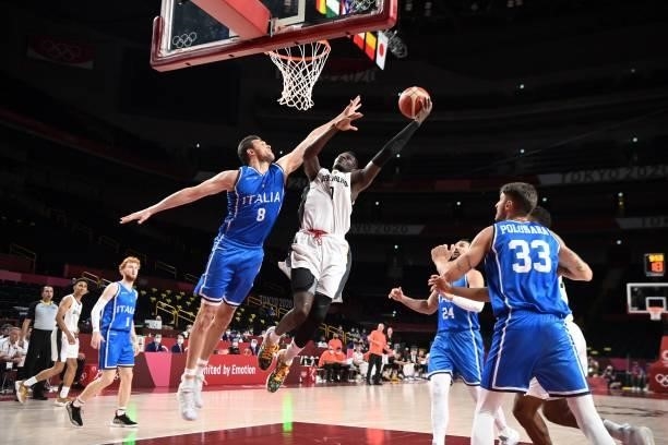 Germany's Isaac Bonga goes to the basket in the men's preliminary round group B basketball match between Germany and Italy during the Tokyo 2020...