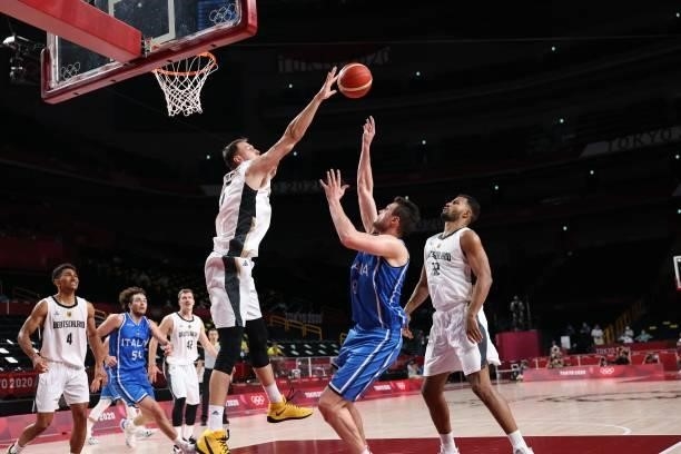 Italy's Danilo Gallinari and Germany's Johannes Voigtmann fight for the ball in the men's preliminary round group B basketball match between Germany...