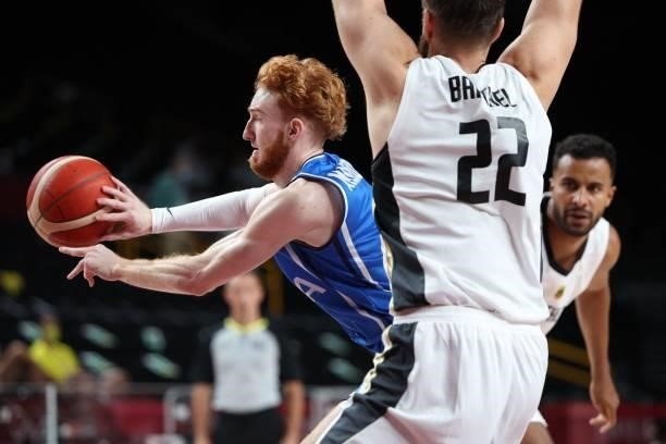 Italy's Niccolo Mannion runs with the ball in the men's preliminary round group B basketball match between Germany and Italy during the Tokyo 2020...