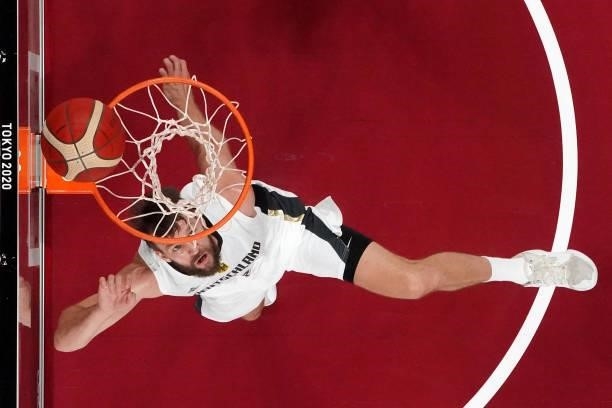 Germany's Danilo Barthel scores a basket in the men's preliminary round group B basketball match between Germany and Italy during the Tokyo 2020...