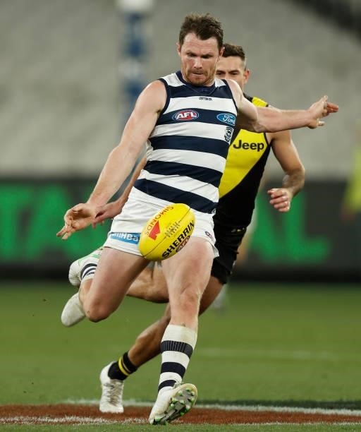 Patrick Dangerfield of the Cats kicks the ball during the 2021 AFL Round 19 match between the Geelong Cats and the Richmond Tigers at the Melbourne...