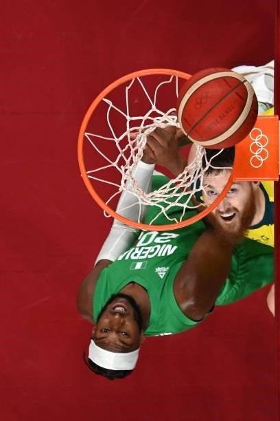 Australia's Aron Baynes scores a basket as Nigeria's Josh Okogie watches in the men's preliminary round group B basketball match between Australia...
