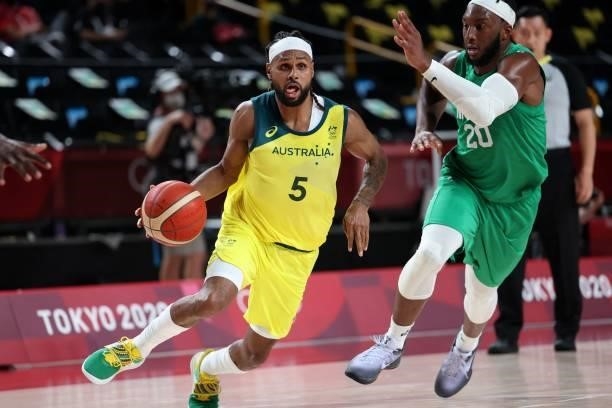 Australia's Patty Mills dribbles the ball past Nigeria's Josh Okogie in the men's preliminary round group B basketball match between Australia and...