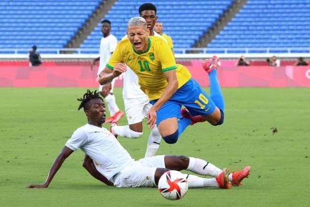 Brazil's forward Richarlison is tackled by Ivory Coast's defender Zie Ouattara during the Tokyo 2020 Olympic Games men's group D first round football...