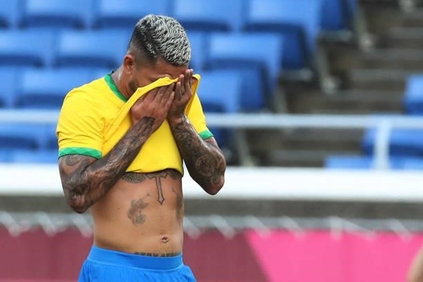 Brazil's midfielder Douglas Luiz reacts as he walks off the pitch after receiving a red card during the Tokyo 2020 Olympic Games men's group D first...