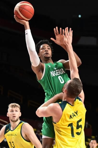 Nigeria's Chikezie Okpala (top0 shoots the ball as Australia's Jock Landale and Nic Kay watch in the men's preliminary round group B basketball match...