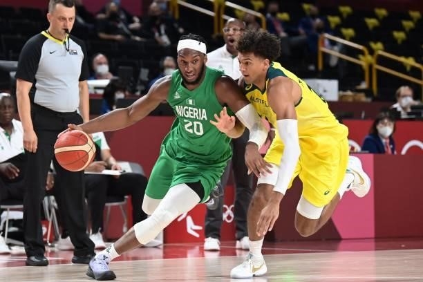Nigeria's Josh Okogie dribbles the ball past Australia's Matisse Thybulle in the men's preliminary round group B basketball match between Australia...
