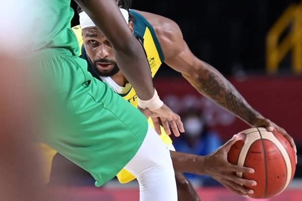 Australia's Patty Mills dribbles the ball in the men's preliminary round group B basketball match between Australia and Nigeria during the Tokyo 2020...
