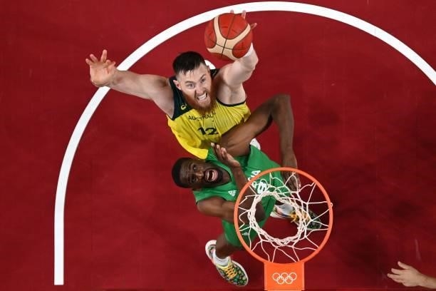 Australia's Aron Baynes goes to the basket as Nigeria's Ekpe Udoh reacts in the men's preliminary round group B basketball match between Australia...