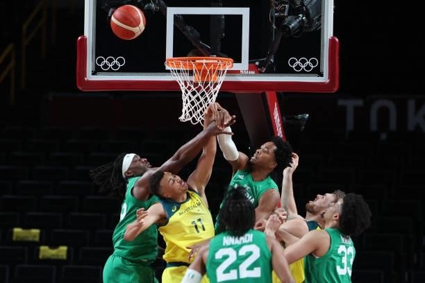 Australia's Dante Exum fights for the rebound with Nigerian players in the men's preliminary round group B basketball match between Australia and...
