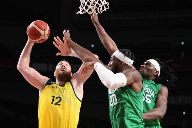 Australia's Aron Baynes goes to the basket as Nigeria's Precious Achiuwa and Nnamdi Vincent try to block in the men's preliminary round group B...