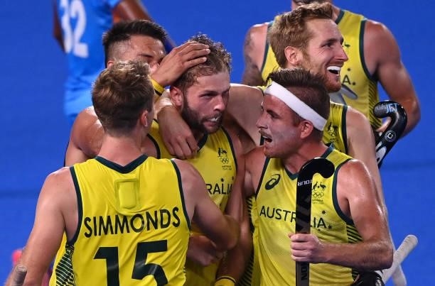Australia's Joshua Beltz celebrates with teammates after scoring against India during their men's pool A match of the Tokyo 2020 Olympic Games field...