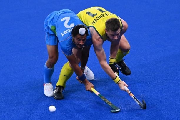 India's Dilpreet Singh and Australia's Edward Clive Ockenden vie for the ball during their men's pool A match of the Tokyo 2020 Olympic Games field...