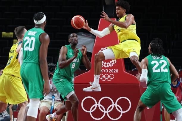 Australia's Matisse Thybulle passes the ball in the men's preliminary round group B basketball match between Australia and Nigeria during the Tokyo...