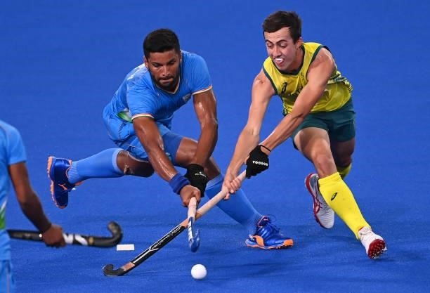 India's Harmanpreet Singh and Australia's Lachlan Thomas Sharp vie for the ball during their men's pool A match of the Tokyo 2020 Olympic Games field...