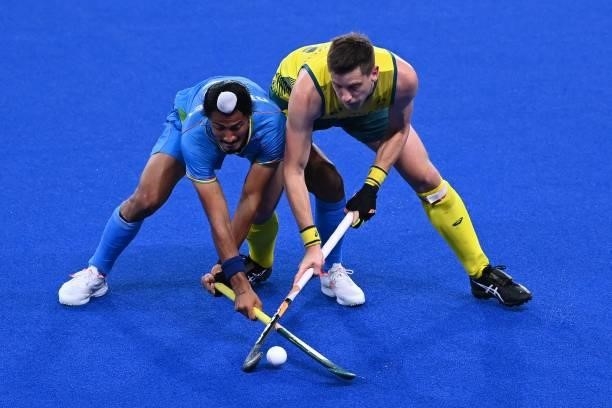 India's Dilpreet Singh and Australia's Edward Clive Ockenden vie for the ball during their men's pool A match of the Tokyo 2020 Olympic Games field...