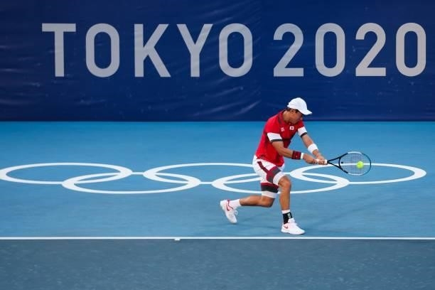 Japan's Kei Nishikori returns a shot to Russia's Andrey Rublev during their Tokyo 2020 Olympic Games men's singles first round tennis match at the...
