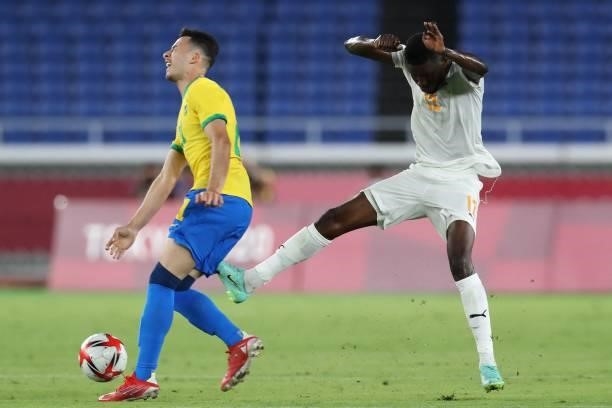 Ivory Coast's midfielder Eboue Kouassi kicks Brazil's Gabriel Martinelli for which he was given his second yellow card during the Tokyo 2020 Olympic...