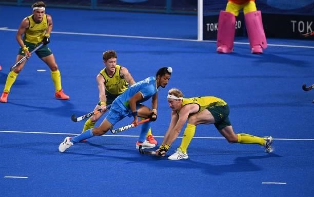 Australia's Matthew Dawson and Aran Zalewski vie for the ball with India's Dilpreet Singh during their men's pool A match of the Tokyo 2020 Olympic...
