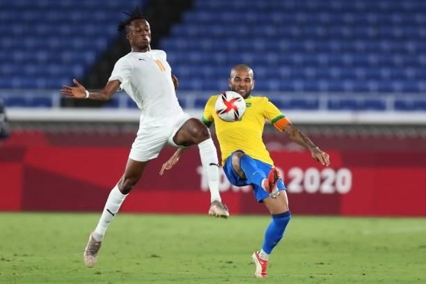Ivory Coast's forward Christian Kouame fights for the ball with Brazil's defender Dani Alves during the Tokyo 2020 Olympic Games men's group D first...