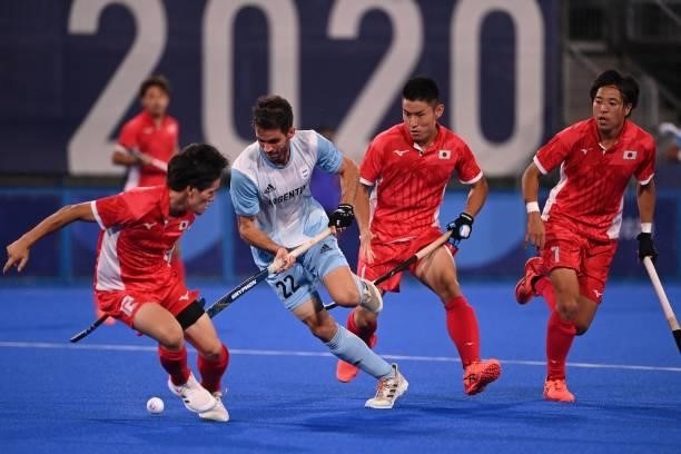Argentina's Matias Alejandro Rey and Japan's Yuma Nagai vie for the ball during their men's pool A match of the Tokyo 2020 Olympic Games field hockey...