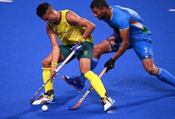 Australia's Blake Govers and India's Rupinder Pal Singh vie for the ball during their men's pool A match of the Tokyo 2020 Olympic Games field hockey...