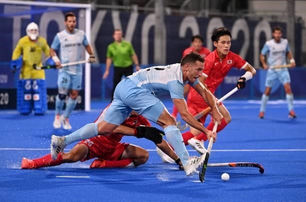 Argentina's Lucas Martin Vila is tackled from the ground by Japan's Masaki Ohashi during their men's pool A match of the Tokyo 2020 Olympic Games...