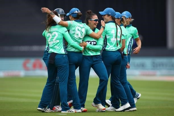 Mady Villiers of the Oval Invincibles celebrates with team mates after dismissing Deandra Dottin of London Spirit during the Hundred match between...