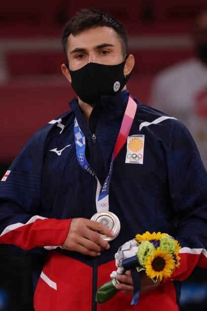 Silver medallist Georgia's Vazha Margvelashvili celebrates during the medal ceremony for the judo men's -66kg contest during the Tokyo 2020 Olympic...