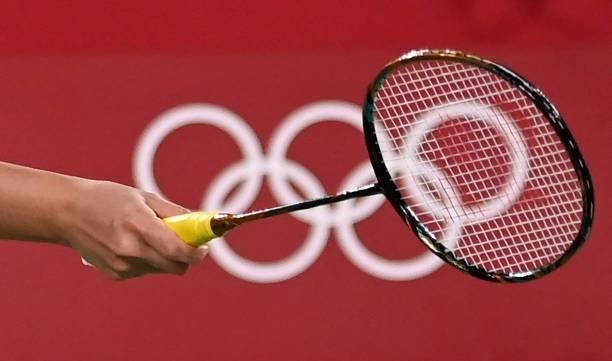 Malaysia's Lee Meng Yean holds her racket in front of the Olympic rings logo in her women's doubles badminton group stage match with Malaysia's Chow...