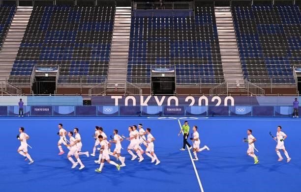 Empty seats are seen as players of Spain warm up before their men's pool A match of the Tokyo 2020 Olympic Games field hockey competition against New...