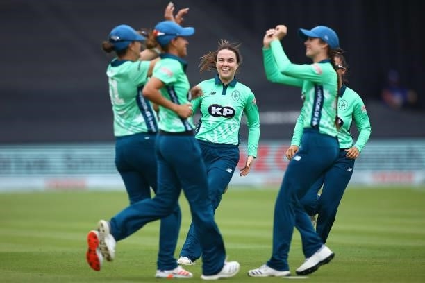 Mady Villiers of the Oval Invincibles celebrates with team mates after dismissing Deandra Dottin of London Spirit during the Hundred match between...
