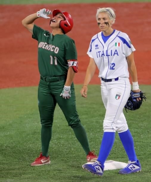 Mexico's Chelsea Gonzales celebrates on the second base after hitting double for an RBI single as Italy's shortstop Amanda Fama walks beside her...