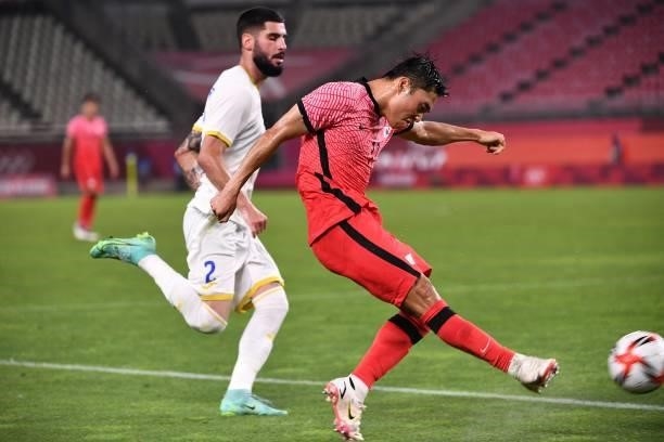 South Korea's forward Lee Dong-jun shoots but fails to score during the Tokyo 2020 Olympic Games men's group B first round football match between...