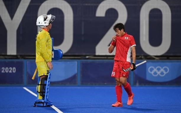 Japan's goalkeeper Takashi Yoshikawa and player Masaki Ohashi are seen during the men's pool A match of the Tokyo 2020 Olympic Games field hockey...