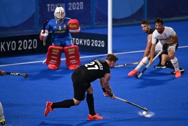 New Zealand's Stephen Jenness strikes the ball to score against Spain during their men's pool A match of the Tokyo 2020 Olympic Games field hockey...