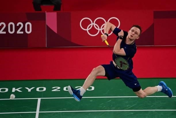 Germany's Kai Schaefer hits a shot to Thailand's Kantaphon Wangcharoen in their men's singles badminton group stage match during the Tokyo 2020...