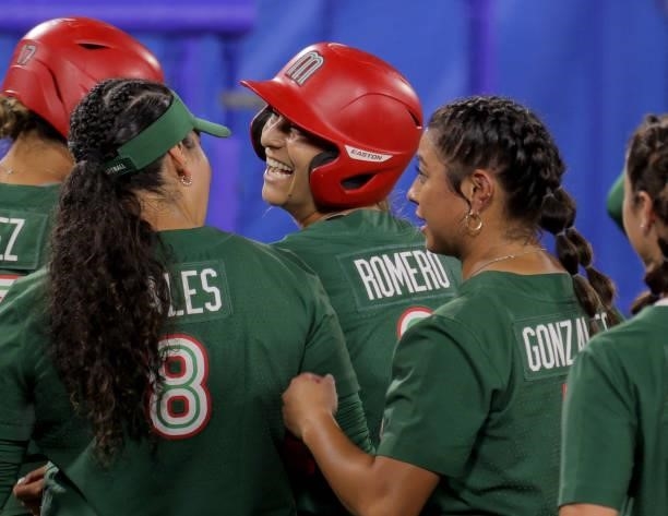 Mexico's Sydney Romero is congratulated by her teammates on her home run during the second inning of the Tokyo 2020 Olympic Games softball opening...