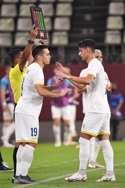 Romania's forward Andrei Sintean replaces Romania's forward George Ganea on the pitch during the Tokyo 2020 Olympic Games men's group B first round...