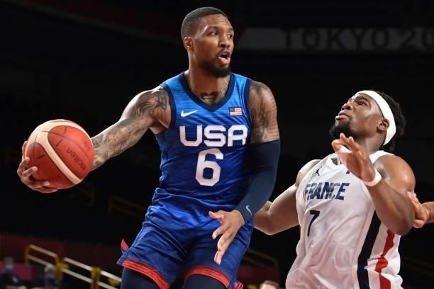 S Damian Lillard tries to pass the past France's Guerschon Yabusele during the men's preliminary round group A basketball match between France and...