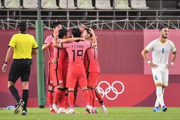 South Korea players celebrate their team's goal during the Tokyo 2020 Olympic Games men's group B first round football match between Romania and...