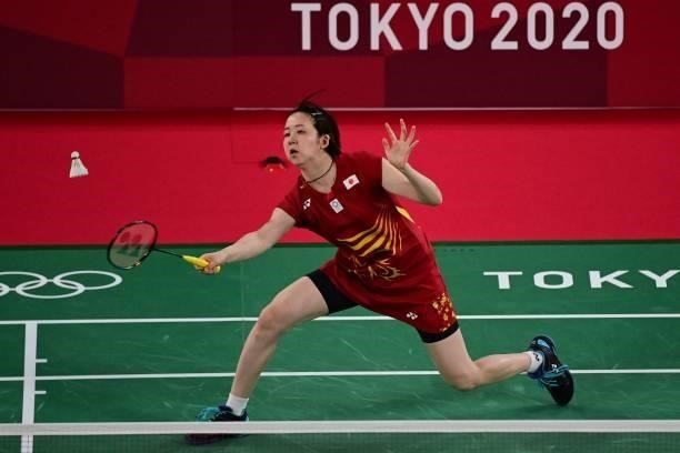 Japan's Wakana Nagahara hits a shot next to Japan's Mayu Matsumoto in their women's doubles badminton group stage match against Canada's Kristen Tsai...