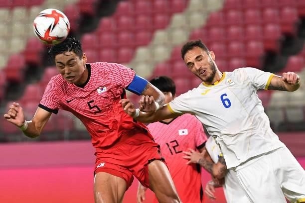 South Korea's defender Jeong Tae-wook heads the ball during the Tokyo 2020 Olympic Games men's group B first round football match between Romania and...