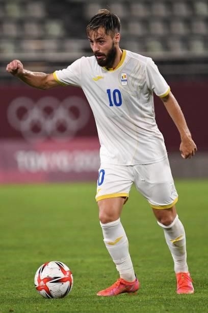 Romania's midfielder Andrei Ciobanu controls the ball during the Tokyo 2020 Olympic Games men's group B first round football match between Romania...