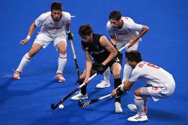 New Zealand's Sean Findlay is marked by Spain's Marc Salles as Spain's Josep Romeu and Vicenc Ruiz look on during their men's pool A match of the...
