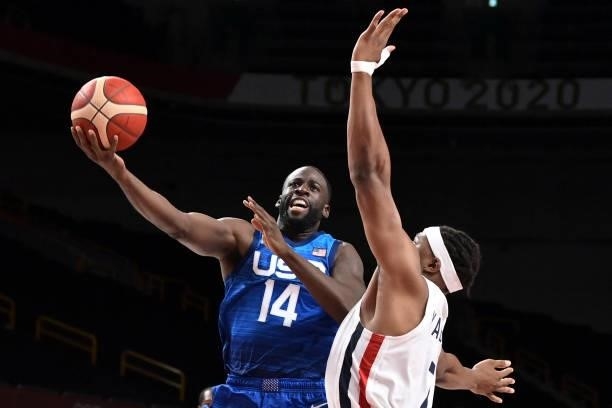 S Draymond Jamal Green goes for the basket past Guerschon Yabusele during the men's preliminary round group A basketball match between France and USA...