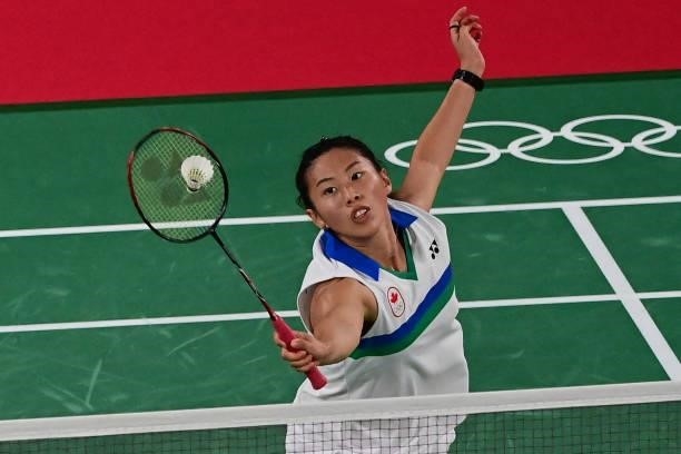 Canada's Kristen Tsai hits a shot in her women's doubles badminton group stage match with partner Canada's Rachel Honderich against Japan's Wakana...