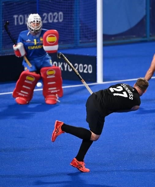 New Zealand's Stephen Jenness strikes the ball to score against Spain during their men's pool A match of the Tokyo 2020 Olympic Games field hockey...