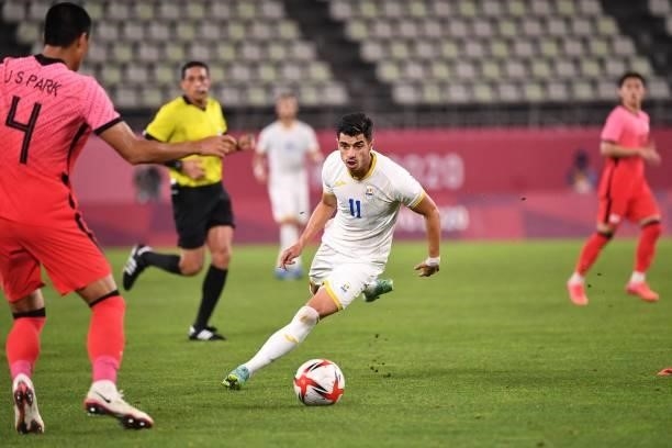 Romania's forward Valentin Gheorghe controls the ball during the Tokyo 2020 Olympic Games men's group B first round football match between Romania...