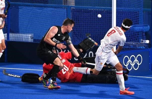 Spain's Enrique Gonzalez scores past New Zealand's goalkeeper Leon Hayward during their men's pool A match of the Tokyo 2020 Olympic Games field...